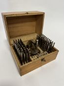 A pine box containing a steel stand with large collection of steel markers (box: 12cm x 19cm x