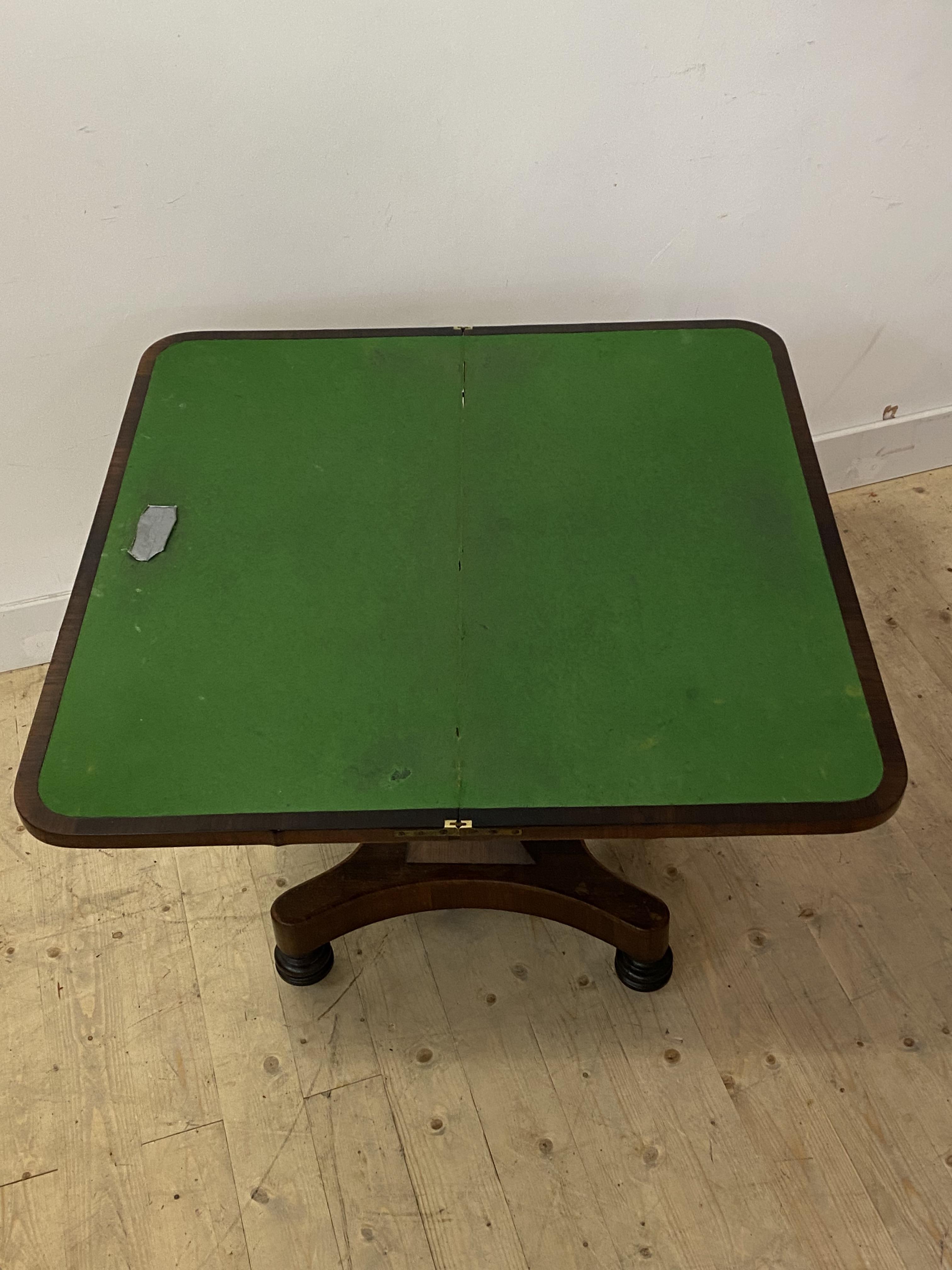 A mid 19th century rosewood card table, the fold over revolving top enclosing a baize lined - Image 3 of 3