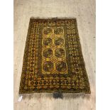 A Turkoman hand knotted bokhara rug, the orange field with eight guls and bordered 137cm x 220cm