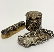An Edwardian Birmingham silver cylinder container with domed top chased with scrolling leaves and