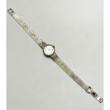 A lady's Vertex Revue white gold wristwatch with circular dial with baton hour markers on Milanese