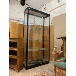 A modern glazed show case, with sliding doors enclosing three adjustable shelves, H199cm, W100cm,