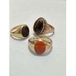 A 14ct gold Tiger's Eye oval cabuchon dress ring, size O, weighs 5.4g and a 9ct gold Agate mounted