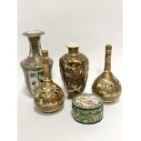 A pair of Japanese bottle neck Satsuma vases decorated with figures enclosed within gilt reserves,