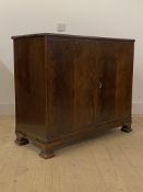 Whytock and Reid, a figured mahogany two door side cabinet, circa 1920s, with moulded edge over