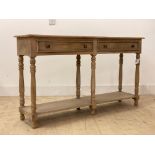 An 18th century style bleached walnut dresser base, fitted with two drawers over turned supports