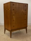 McIntosh, A mid century teak chest, fitted with five drawers, raised on square tapered supports,