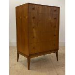 McIntosh, A mid century teak chest, fitted with five drawers, raised on square tapered supports,