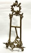 An Edwardian style cast brass picture easel of C scroll and S scroll design and tripod stand, (56cm,