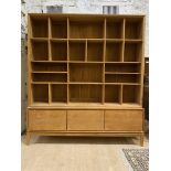 A Contemporary bespoke hardwood bookcase, the top section fitted with a combination of shelves and