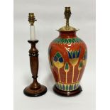 A modern Egyptian inspired terracotta glazed baluster vase table lamp, on hardwood stand, with