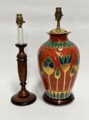 A modern Egyptian inspired terracotta glazed baluster vase table lamp, on hardwood stand, with