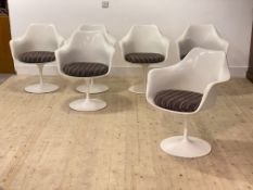A set of six mid century Tulip chairs, white moulded fibreglass seats with squab cushions, raised on