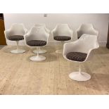 A set of six mid century Tulip chairs, white moulded fibreglass seats with squab cushions, raised on