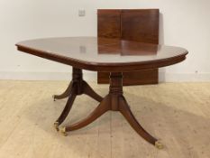 A Regency style inlaid mahogany twin pillar dining table, the top with two 'D' ends and two leaves