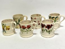 A group of six Emma Bridgewater pottery mugs including strawberry pattern, heart pattern and four