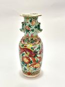 A Chinese late 19thc baluster vase decorated with four clawed pink and white dragon chasing the