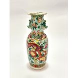 A Chinese late 19thc baluster vase decorated with four clawed pink and white dragon chasing the