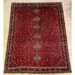 A Caucasian hand knotted carpet, the red field with pole medallion and intricately decorated with