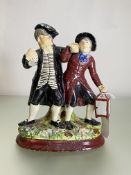 A Staffordshire "Drunken Parson" group, 19th century, one figure with a foaming tankard, the other a