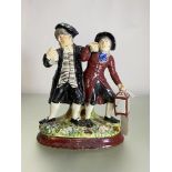 A Staffordshire "Drunken Parson" group, 19th century, one figure with a foaming tankard, the other a