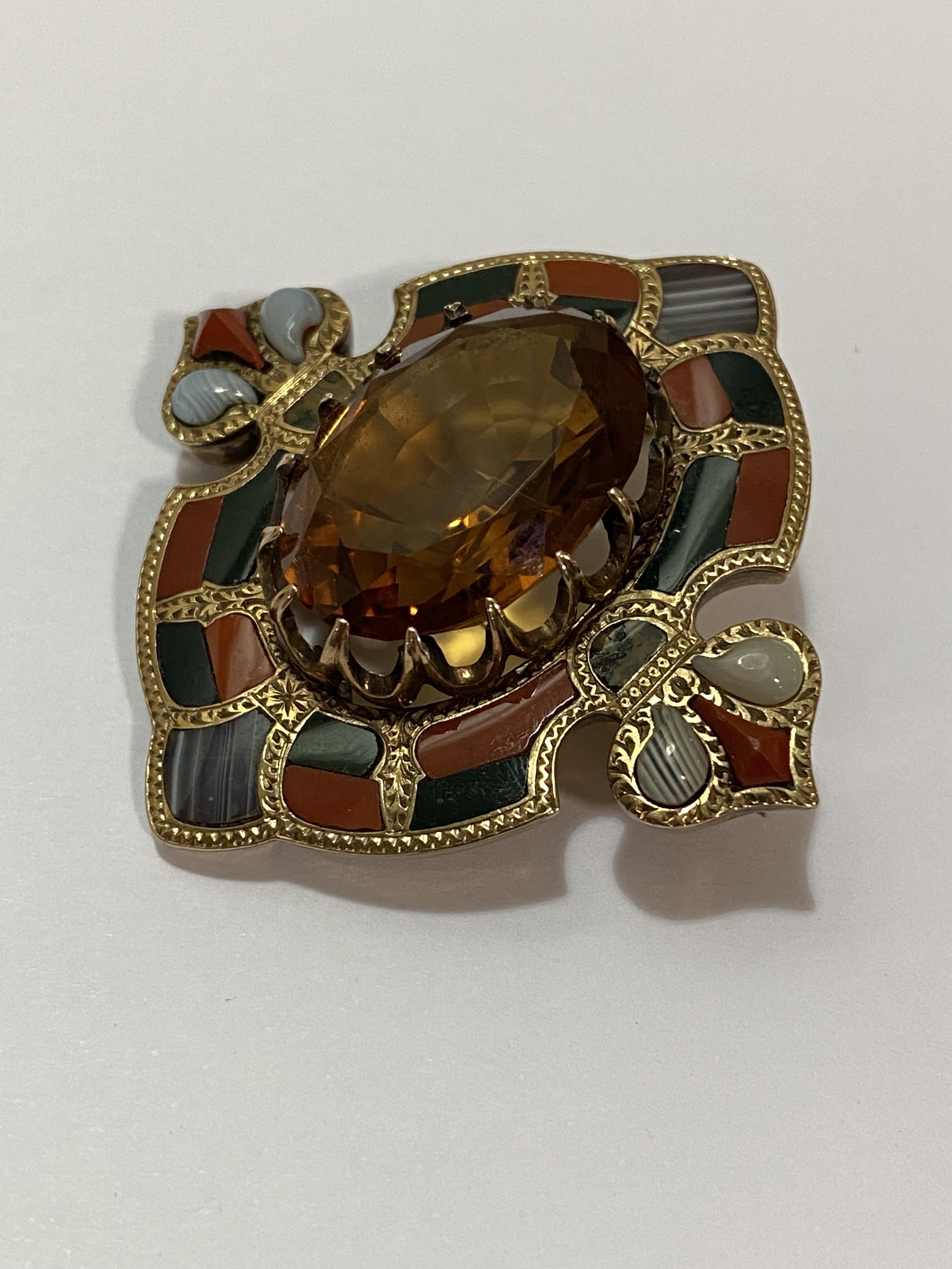 A late 19th century Scottish yellow metal mounted citrine and hardstone brooch, centred by a large