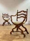 A pair of cherrywod X-frame chairs, early 20th century, the wavy splat back with turned finials over
