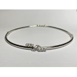 A white gold (unmarked, untested) diamond-set articulated necklet, the design en suite with the