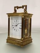 A Swiss brass-cased carriage clock for Matthew Norman Retailers, London, the lacquered brass case