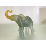 A Daum pate de verre model of an elephant, in smoky blue and amber glass, etched mark, in original