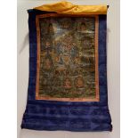 A Tibetan thangka, 19th/20th century, depicting a wrathful deity surrounded by figures and
