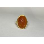 A carved hardstone intaglio ring, the oval agate with a profile bust of a young lady, on an (