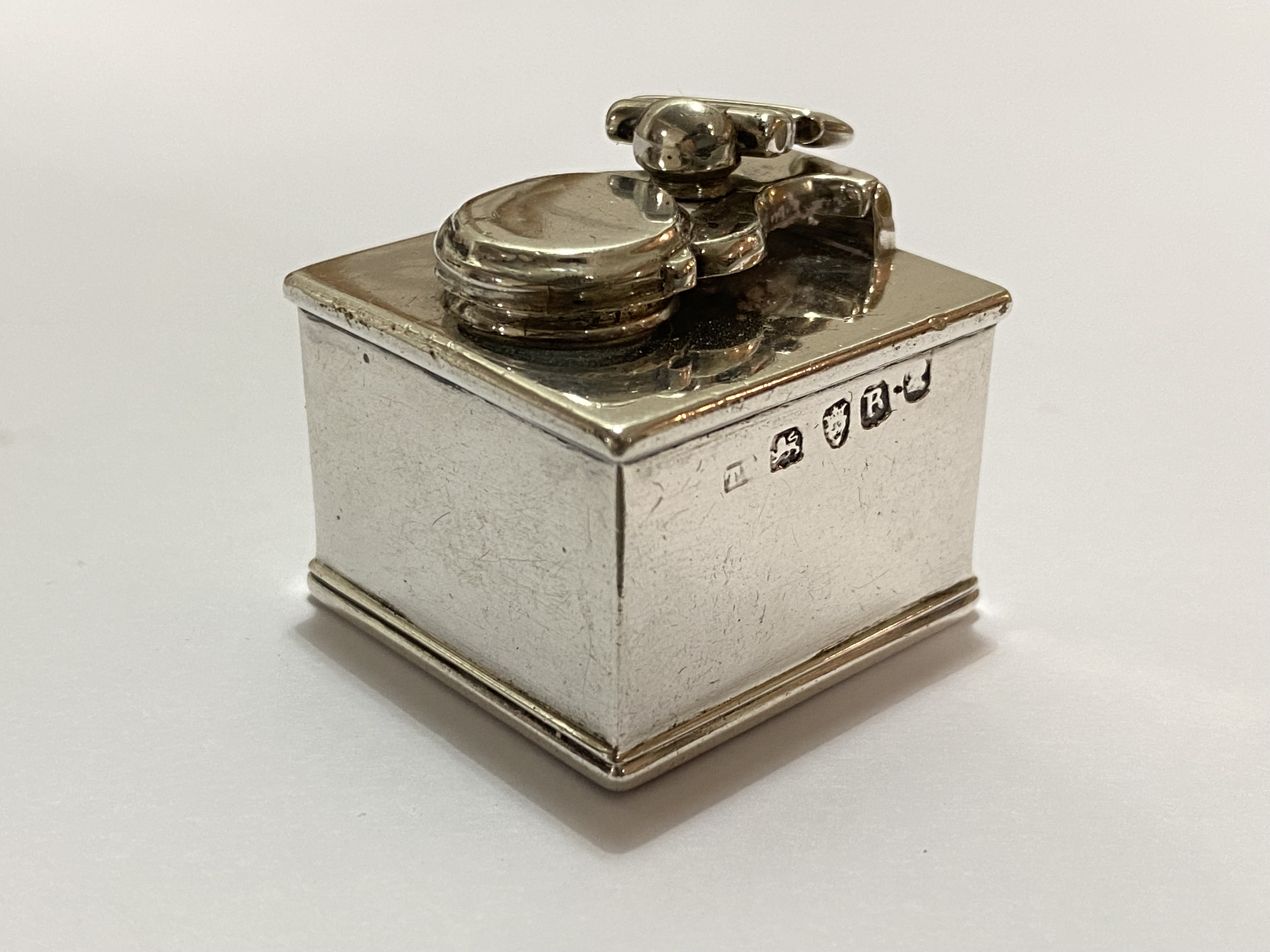 A George III silver travelling inkwell, London 1812 (maker's mark indistinct), of cube form, the