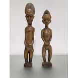 Two Baule standing wooden figures, Ivory Coast, 20th century, each with crested coiffure and