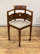 An Arts and Crafts period mahogany corner chair, the crest rail and pierced back over upholstered