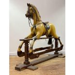 A Whittingham Crafts Ltd. carved and painted wooden trestle rocking horse, painted mustard, with