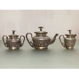 A South-East Asian white metal three piece tea service, c. 1900, probably Siam, each piece with