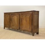 A French Provincial oak sideboard, c. 1800, the two plank top with channel back and moulded edge