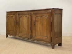 A French Provincial oak sideboard, c. 1800, the two plank top with channel back and moulded edge