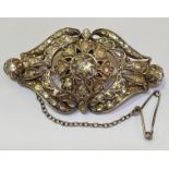 A mid-19th century diamond brooch, mounted in yellow gold and silver, of shaped lozenge form, the