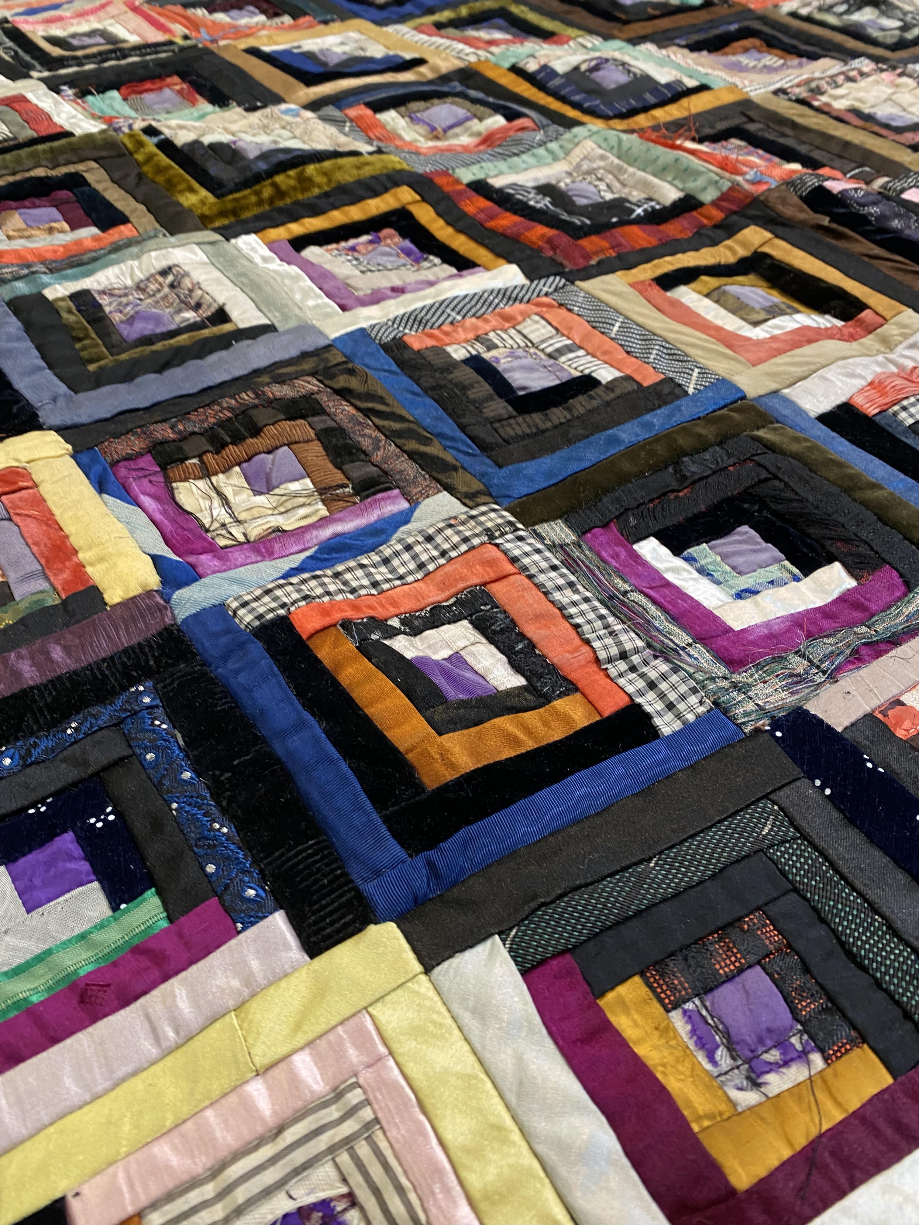 An early 20th century velvet, silk and satin patchwork quilt, worked with coloured scraps in - Image 2 of 3