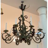 A patinated wrought iron chandelier in Baroque style, early 20th century, the hammered copper boss