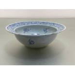 A Chinese blue and white porcelain basin, the well and broad rim painted with flowerheads amidst