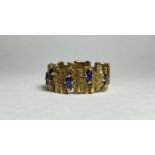 A vintage sapphire-set 9ct gold ring, the textured bark band claw-set with marquise-cut sapphires.