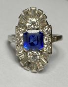 A sapphire and diamond cluster ring in the Art Deco taste, the central square-cut sapphire claw-