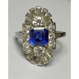 A sapphire and diamond cluster ring in the Art Deco taste, the central square-cut sapphire claw-