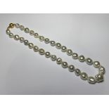 A graduated cultured baroque Tahitian South Sea pearl single strand necklace, mounted on a diamond-