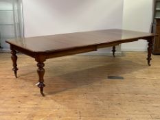 A large mid-19th century mahogany dining table, the rectangular top with rounded corners pulling out