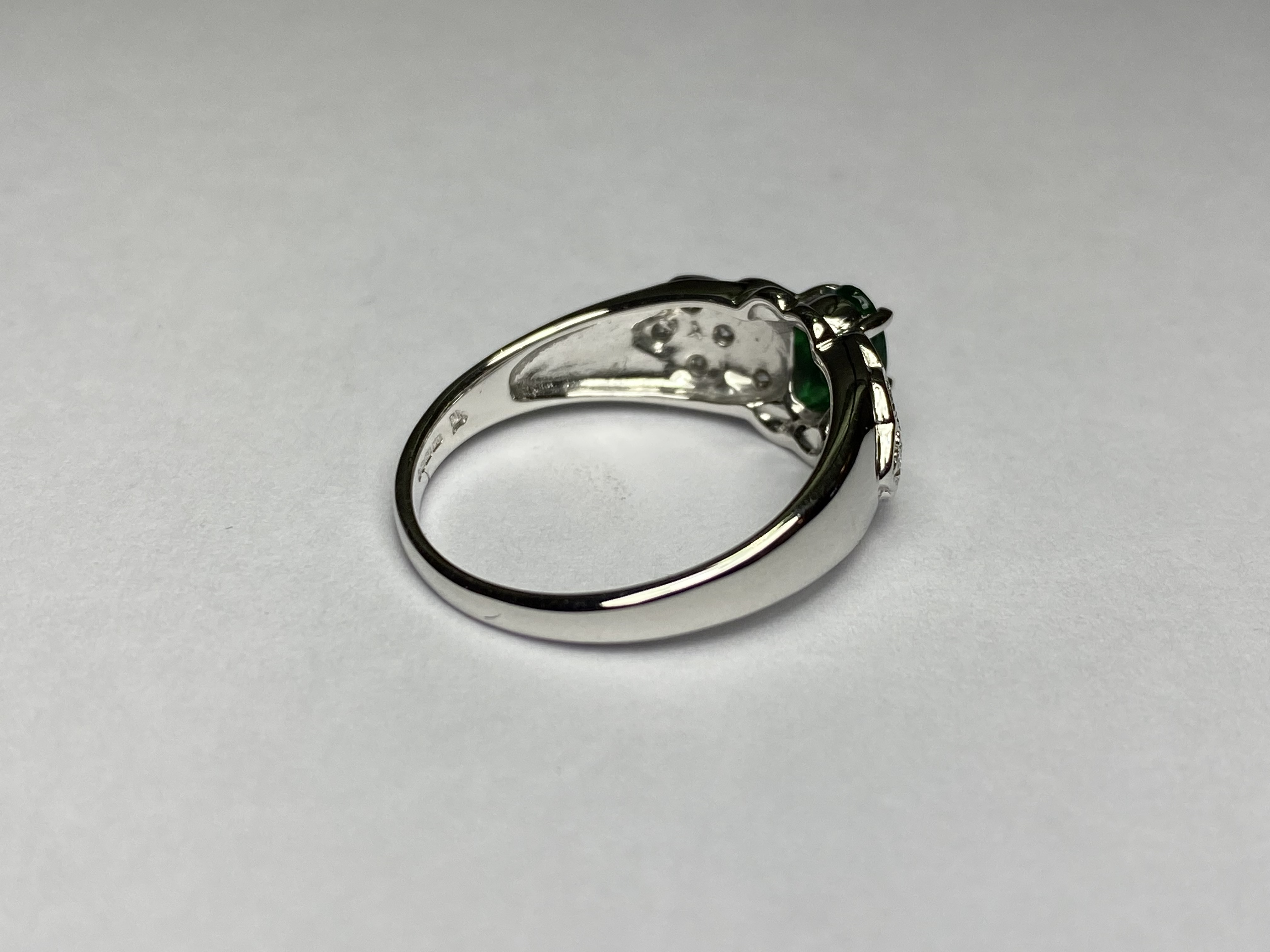 An emerald and diamond cluster ring, the central oval-cut emerald claw-set on a shaped plaque of - Image 2 of 3