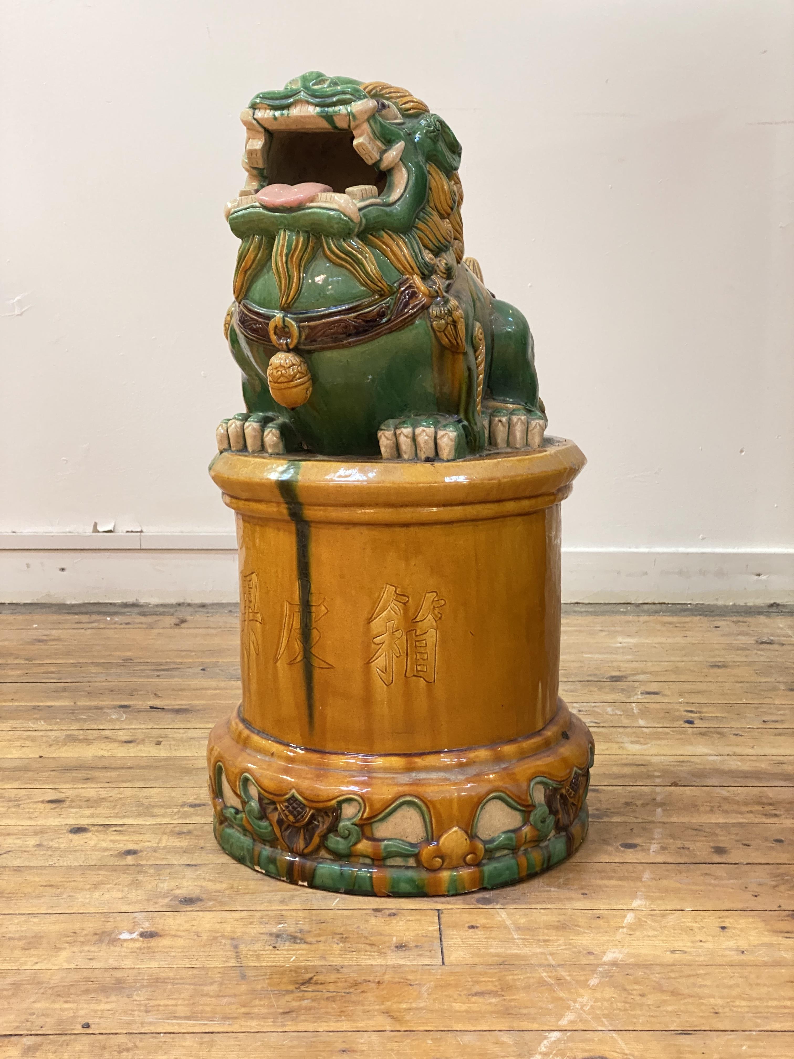 An unusually large Chinese pottery incense burner, modelled as a Buddhistic temple lion, in a Sancai